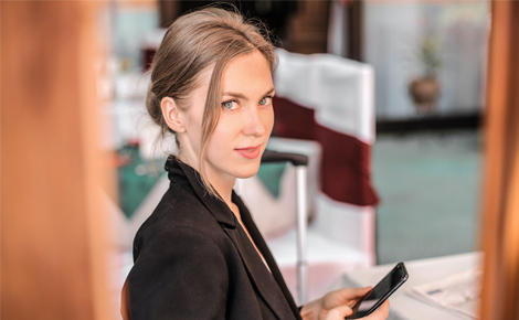 photo of a woman holding mobile phone