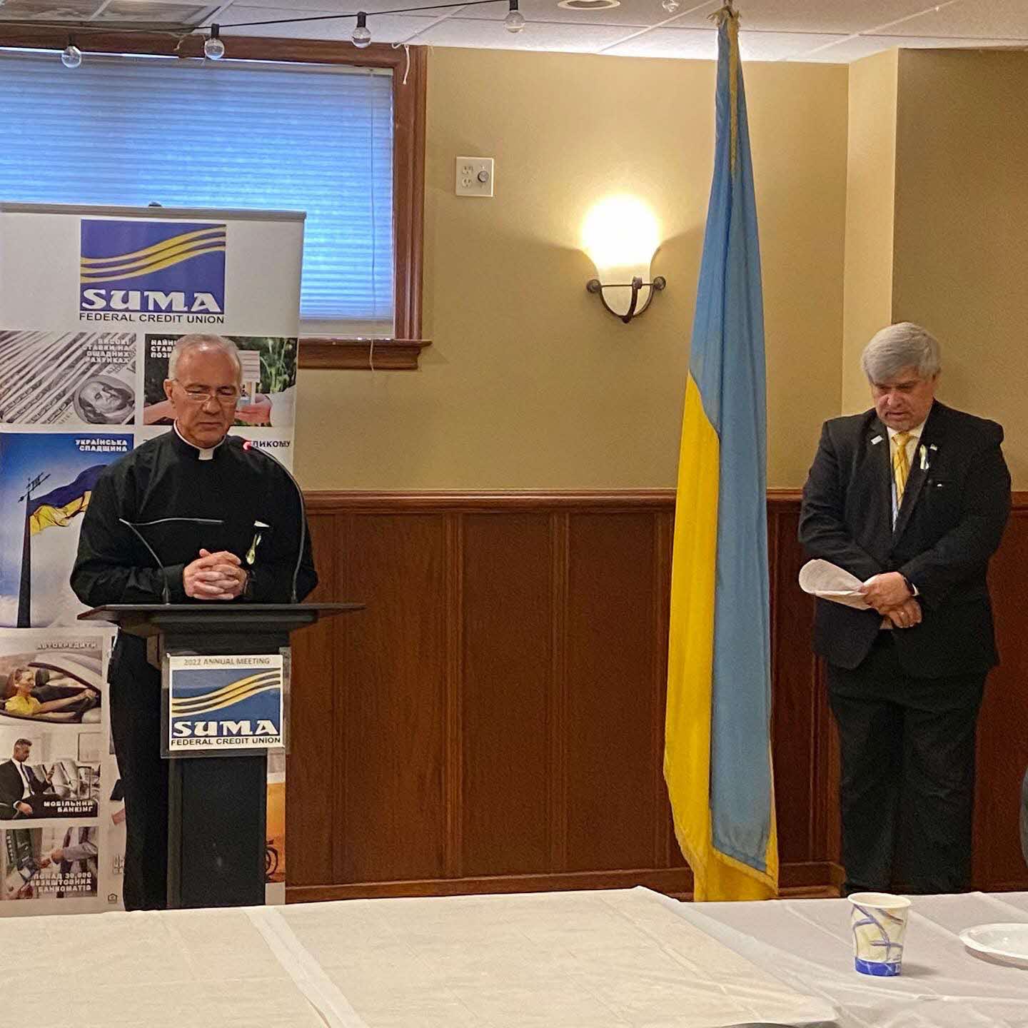 The priest is praying at the annual meeting opening