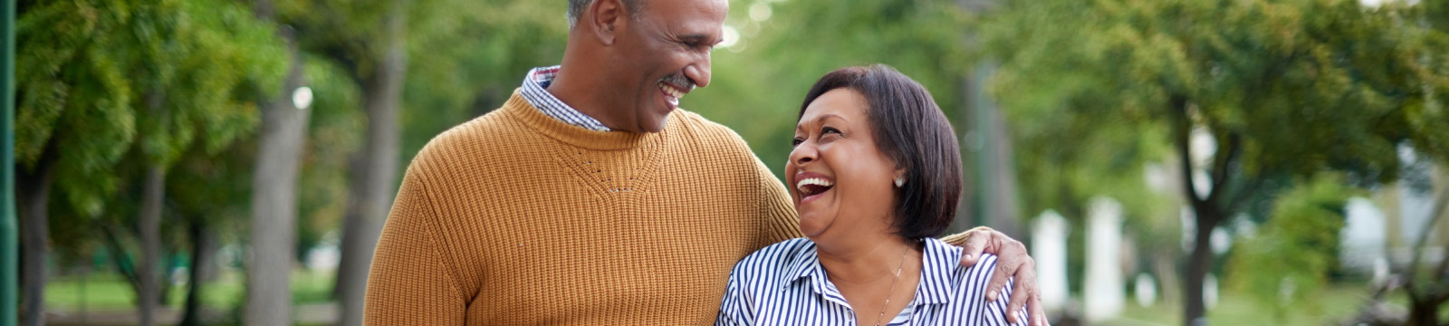 Mature couple enjoy a walk outside.